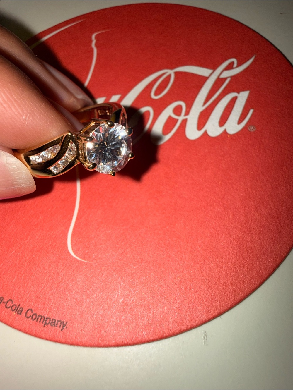 Gold tone solitaire ring with clear center stone